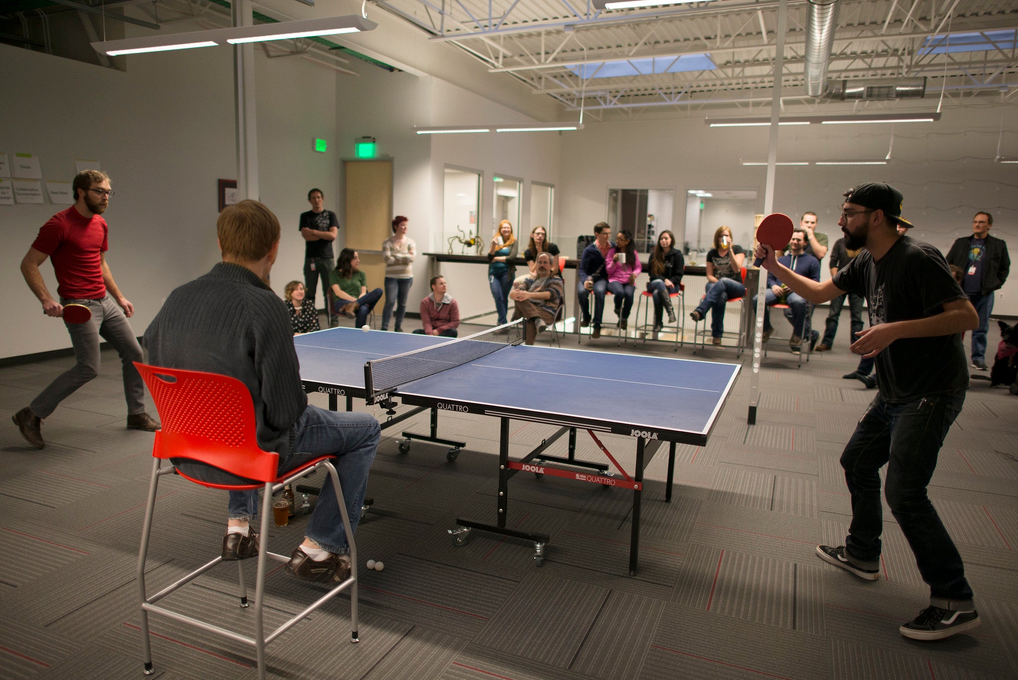 Two men playing a game of ping pong.